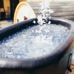 Ice being poured into a cold plunge tub for recovery and inflammation control for BJJ athletes over 40