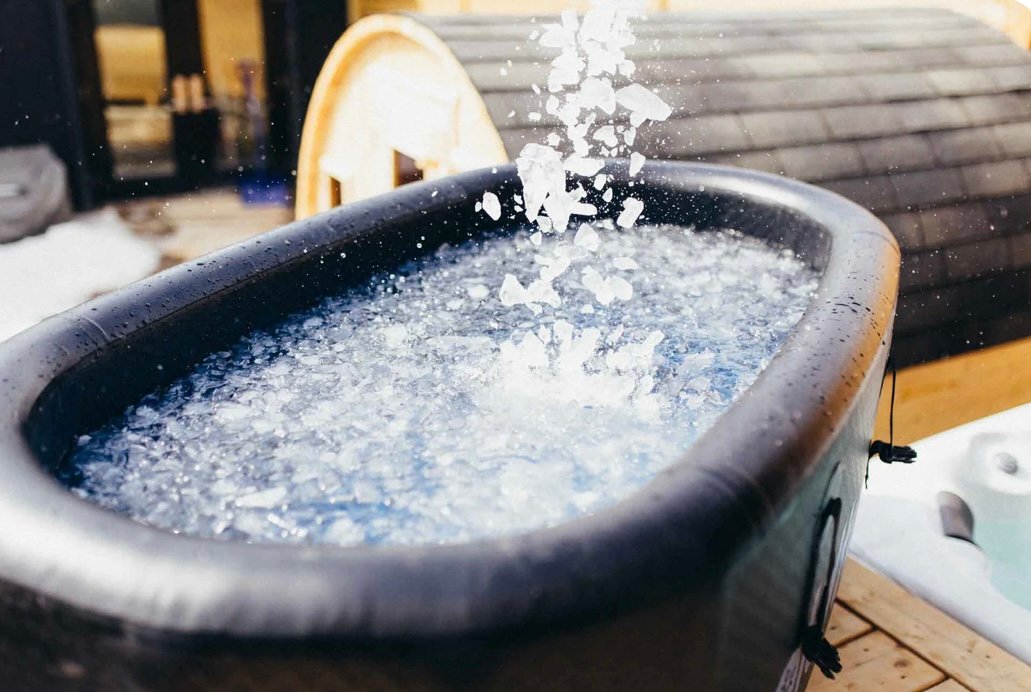 Ice being poured into a cold plunge tub for recovery and inflammation control for BJJ athletes over 40