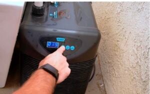 cold-plunge-temperature-control-for-bjj-recovery.jpg Hand adjusting cold plunge temperature to follow safe recovery protocols for BJJ athletes over 40