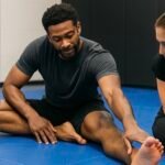 BJJ Mobility Stretching for Recovery BJJ athlete stretching on the mats to improve mobility and recovery